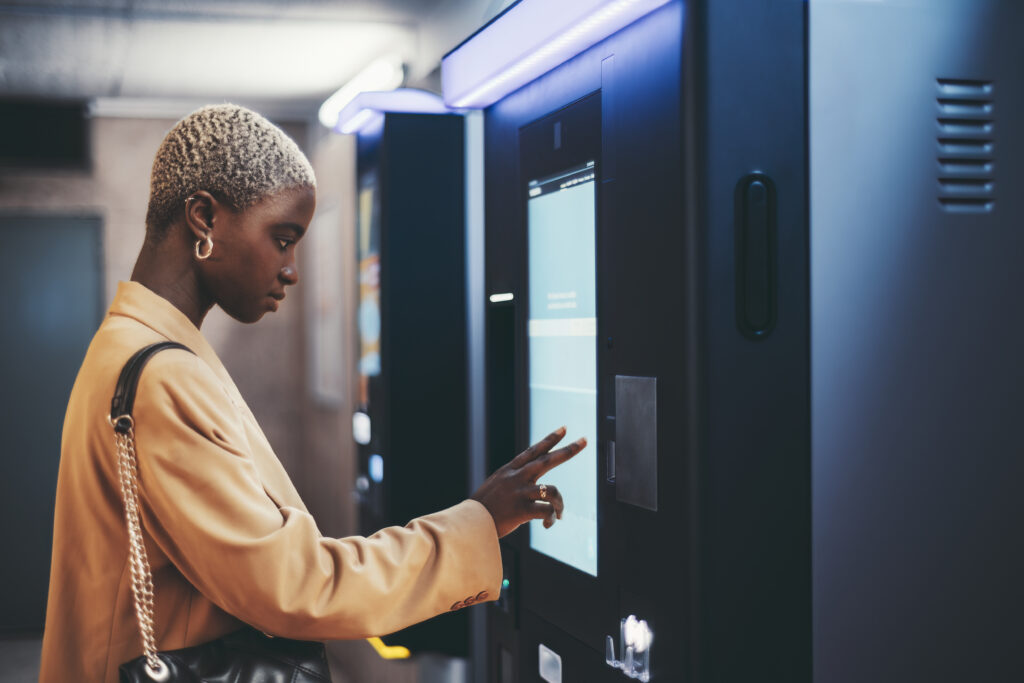 African Girl Using Ticket Terminal